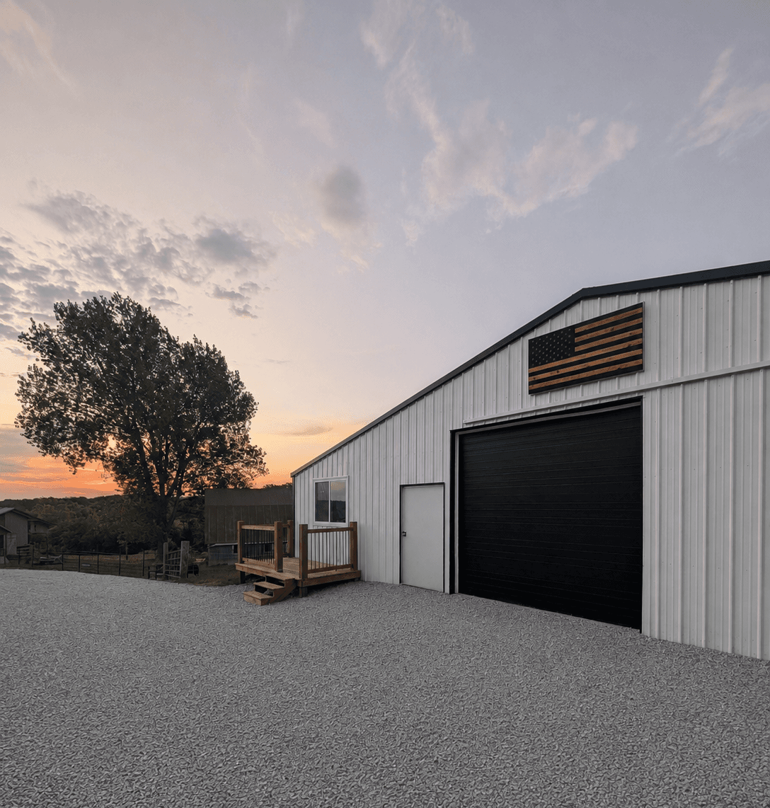 The white and black shop that houses the club office, its wooden deck and check-in window on the near side, at sunset