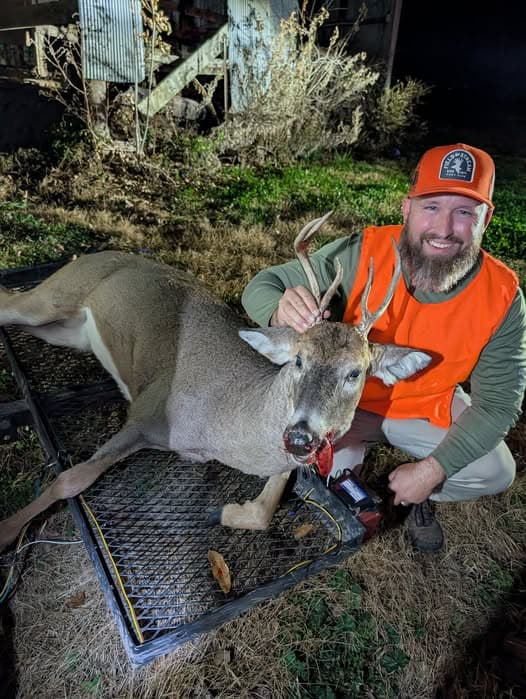 A member with a harvested whitetail buck