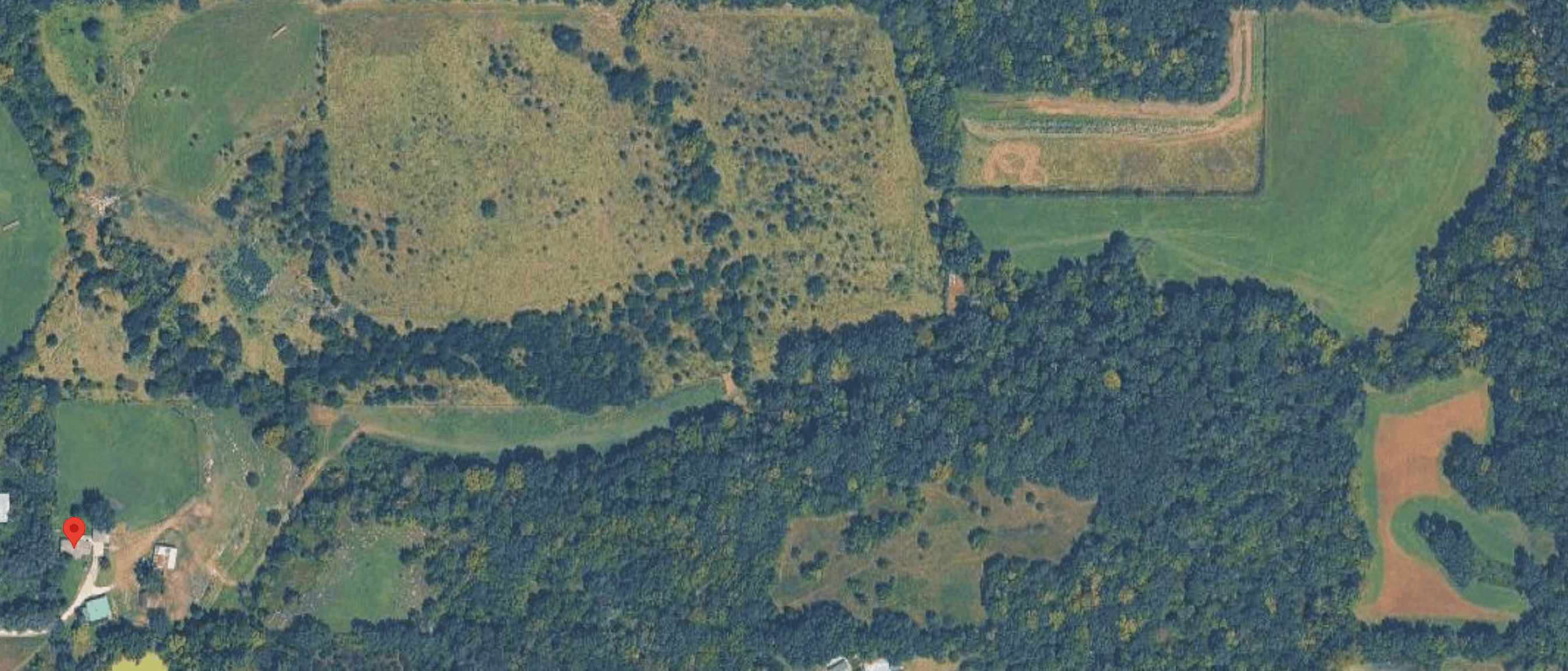 Aerial view of the property's fields and timber