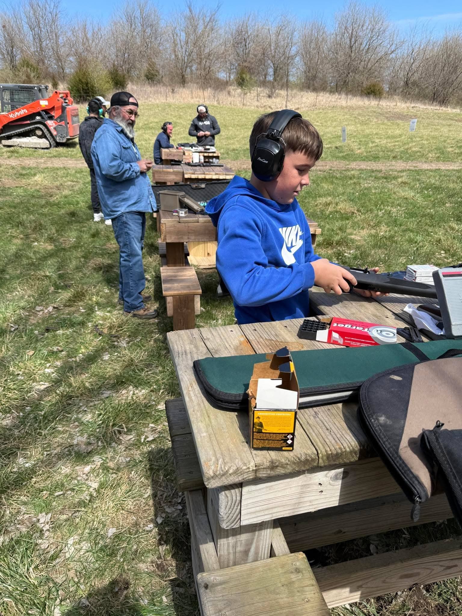 Open-air shooting benches looking downrange toward distant targets